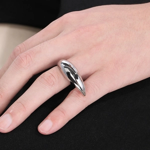 Macro shot of silver crescent ring with a polished finish on a model's hand
