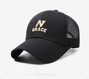 Detail of black mesh trucker hat featuring beige Grace N embroidery and breathable back