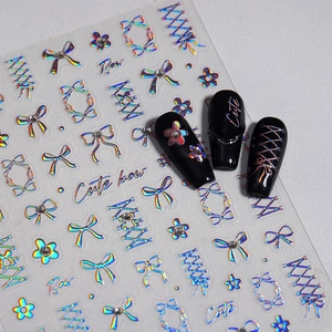 3D holographic bow and floral nail stickers with glitter finish on black nails