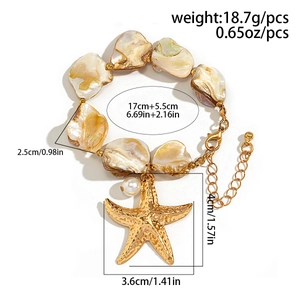 Macro shot of gold starfish and natural shell charms on a bohemian summer necklace