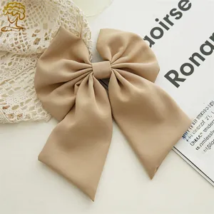 Detailed texture of an elegant beige bow hair clip styled with French lace elements