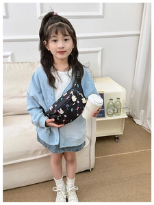 Detail of kids black nylon waist bag with colorful rabbit prints and dual bunny zippers