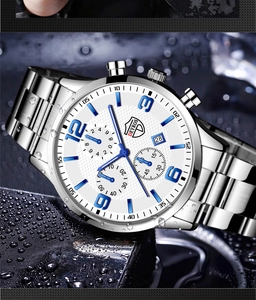 Detail of silver stainless steel watch with white dial and blue numerals on a water surface