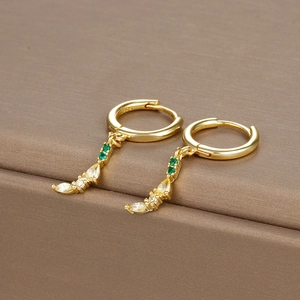 Macro shot of S925 sterling silver gold hoop earrings with green and yellow zircons