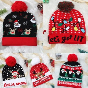 Detail showcasing five Christmas knitted hats with festive patterns and faux fur pom-poms