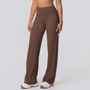Detail of high waisted flared yoga pants in dark brown fabric with a sleek loose fit