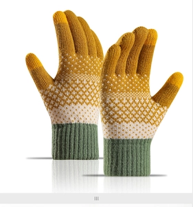 Detail of color-block knitted gloves with diamond jacquard and ribbed cuffs for winter