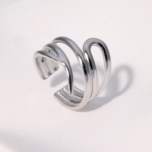 Macro detail of minimalist silver multilayer wavy stainless steel ring from a side angle