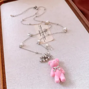 Pink flocked bear pendant necklace with pearls and elegant tassels for casual sweater wear