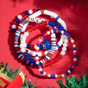 Detail of red white and blue USA beaded bracelets with clay discs and star charms