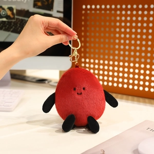 Funny red peanut-shaped plush keychain with cute embroidered face and gold ring clip