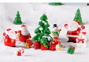 Miniature resin Christmas figurines featuring Santa and snowman in a snowy scene
