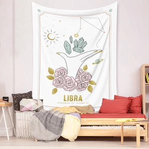 Close-up of Libra zodiac wall tapestry with floral hand design and golden celestial motifs