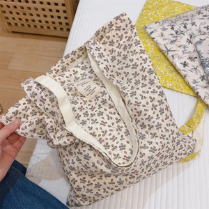 Minimalist cotton canvas tote bag with butterfly patterns and brand label