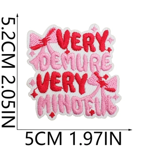 Close-up of Very Demure embroidery patch with pink bow and star details for accessories