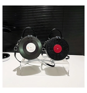 Close-up of vintage vinyl record shaped handbags with musical elements and silver zippers