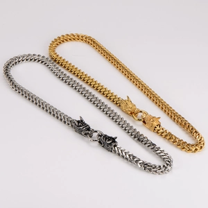 Close-up of gold and silver Franco chains with double dragon head clasps for men