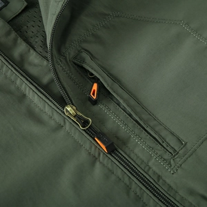 Detail of waterproof green jacket with anti-slip zippers and breathable mesh lining