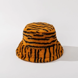 Close-up of tiger print plush bucket hat texture with orange and black faux fur