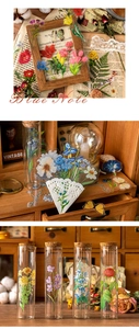 Detail of vintage waterproof PET floral stickers on glass bottles and old music sheets