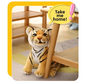 Detailed close-up of a lifelike orange plush tiger doll with soft faux fur texture