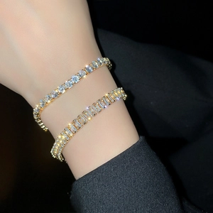 Elegant gold bracelet with square zircon and round rhinestones shown on a female wrist