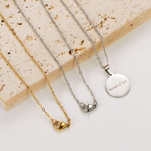 Detail of Harvest of Love engraved round pendants on gold and silver chain necklaces
