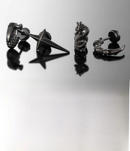 Detail of silver titanium steel earrings set featuring dragon and grenade motifs