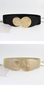 Close-up of elastic waist belts with circular sunburst texture golden buckles in black and gold