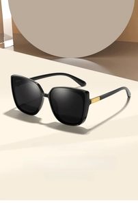Detail of square oversized sunglasses with black frame and gold metal temple hinge decor