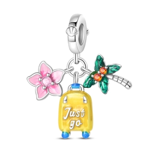 Macro detail of silver charm with enamel coconut tree, pink flower, and Just Go suitcase