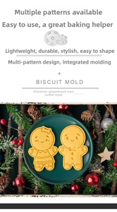 Detail of gingerbread man cookie molds set on a plate with Christmas holiday decorations