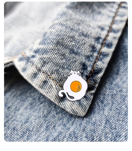 Cute white cat enamel pin with a fried egg pattern on a blue denim collar