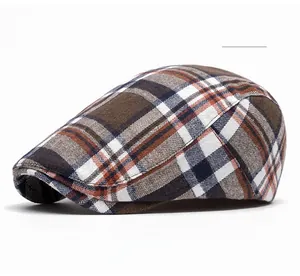 Close-up of the vintage coffee plaid texture on this stylish British newsboy flat cap