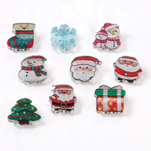 Nine-piece Christmas hair claw clip set with glitter trees, snowmen, and festive shapes