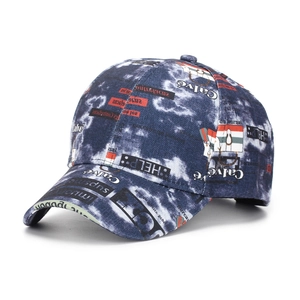 Detail showing the denim tie-dye fabric texture and graffiti patterns on this street style cap