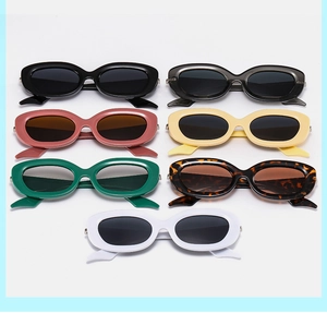 Flat lay of retro oval sunglasses in seven colors including leopard and cream white