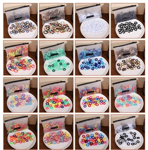 Macro view of elastic hair tie sets in 16 colors with cute duck storage pouches