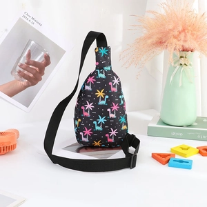 Detail of durable black nylon kids chest bag with colorful dinosaur and palm tree patterns