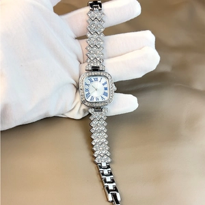 Elegant silver square watch with Roman numerals and rhinestone strap on display
