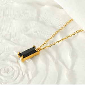 Detailed shot of 18K gold plated necklace featuring a rectangular black zircon pendant