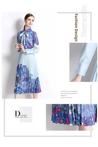 Detail of floral printed pleated dress featuring bow tie collar and elegant sleeve cuffs