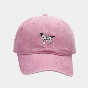 Close-up of pink washed cotton baseball cap with detailed puppy embroidery and retro finish