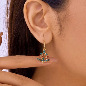 Close-up of a Christmas tree earring with gold plating and colorful rhinestones