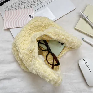 Detail of yellow plush teddy fleece hat showing capacity with phone and glasses inside