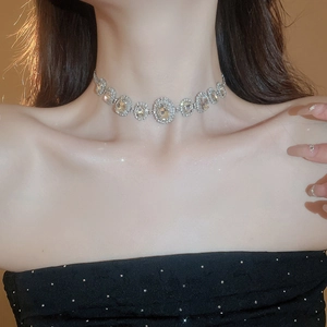 Close-up of elegant silver choker necklace with large oval crystals on a model