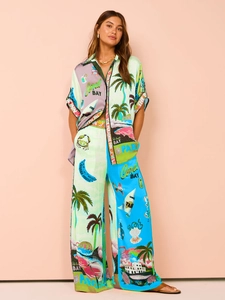 Close-up of tropical print two-piece set featuring short-sleeve shirt and wide-leg trousers