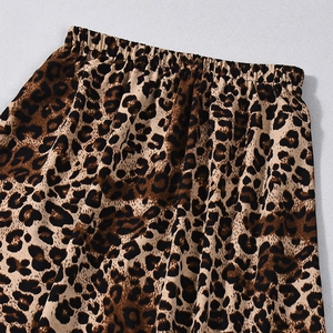 Detail view of the elastic high waist and leopard print fabric of the long skirt