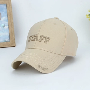 Detailed close-up of beige cotton baseball cap with STAFF 3D embroidery on canvas