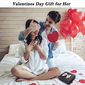 Elegant black gift box with pink bow featured in a romantic Valentine's Day setting